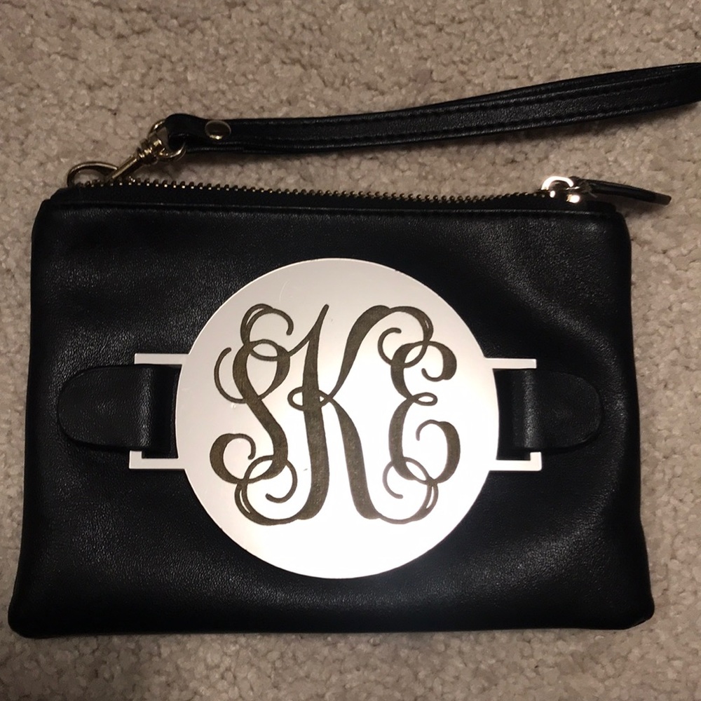 SKE monogrammed black clutch